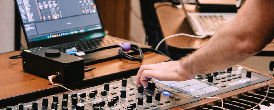 Music producer recording an arturia synth into Ableton Live