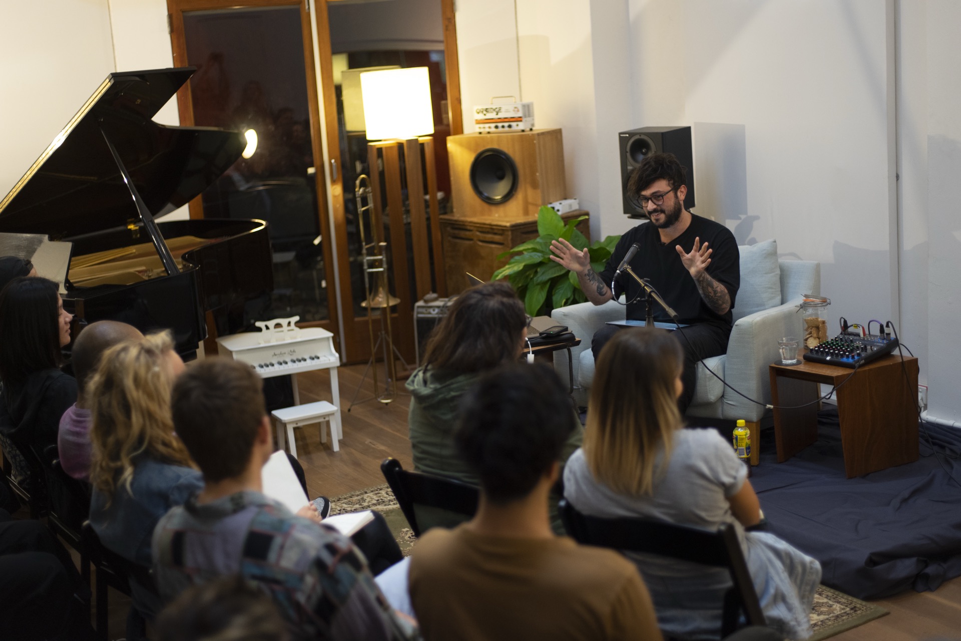 music industry guest speaker talking with students in a recording studio