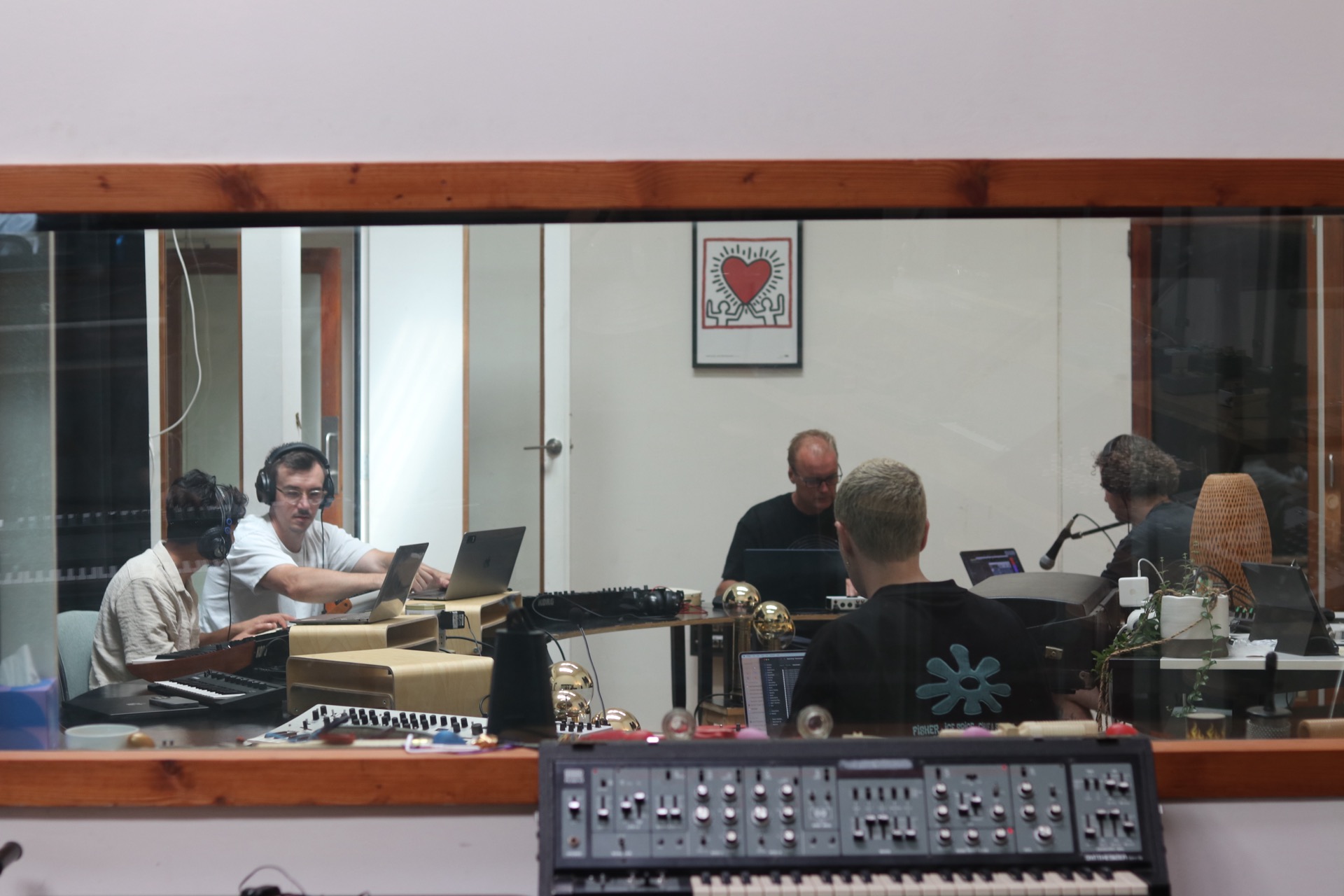 View from studio 2 to studio 1 where students are producing music