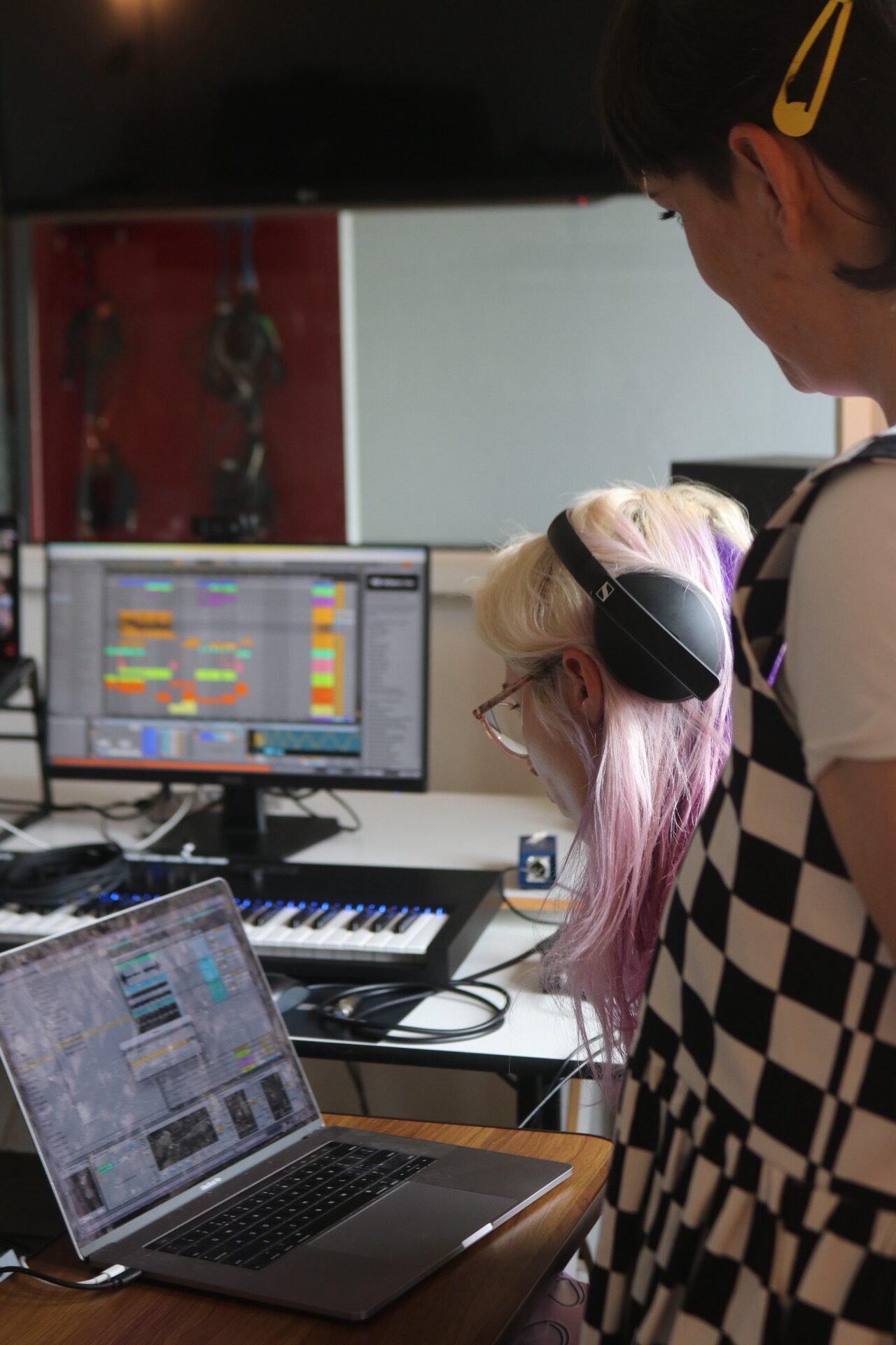 students working together in the studio on an original track.