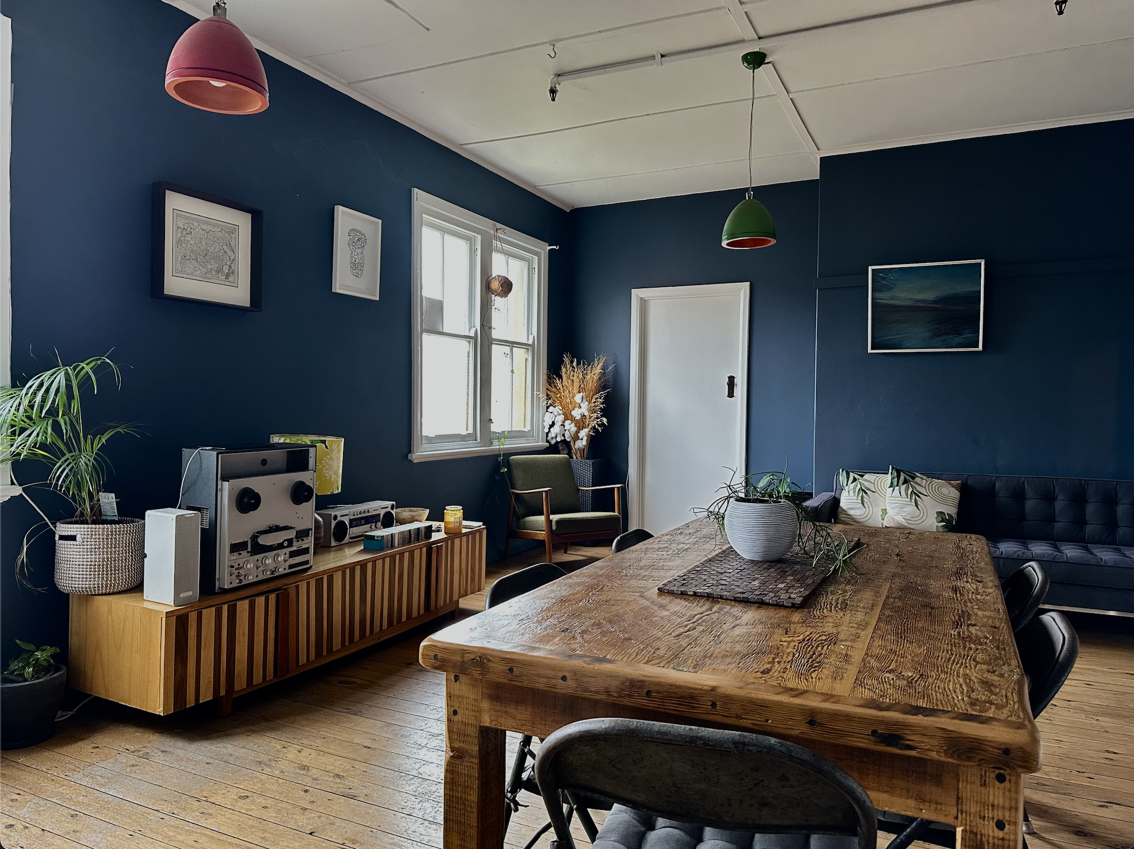 Casual studio hangout space with bar-style kitchen and couches