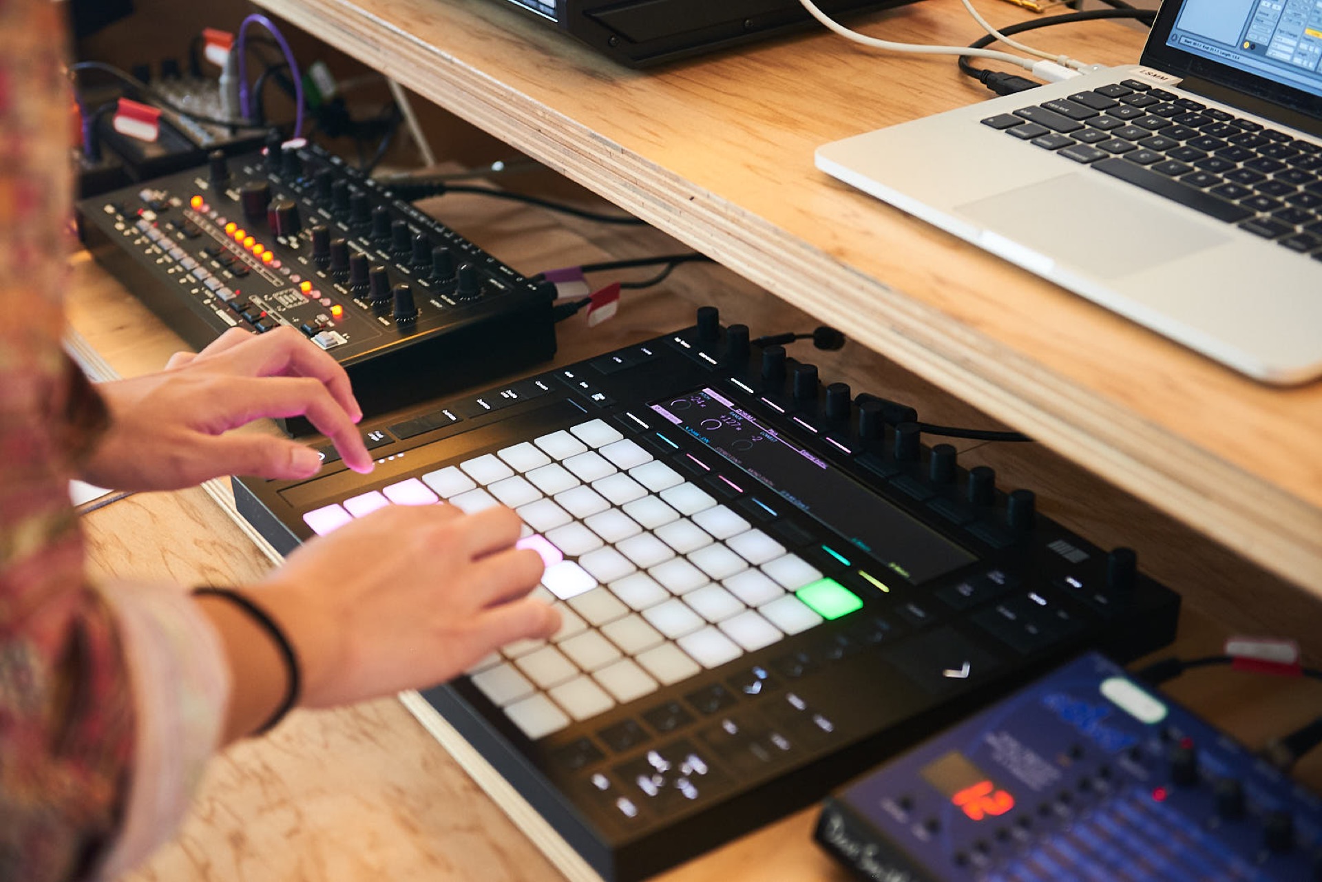 student using Ableton Push to sequence an Abstrakt Avalon Bassline synth