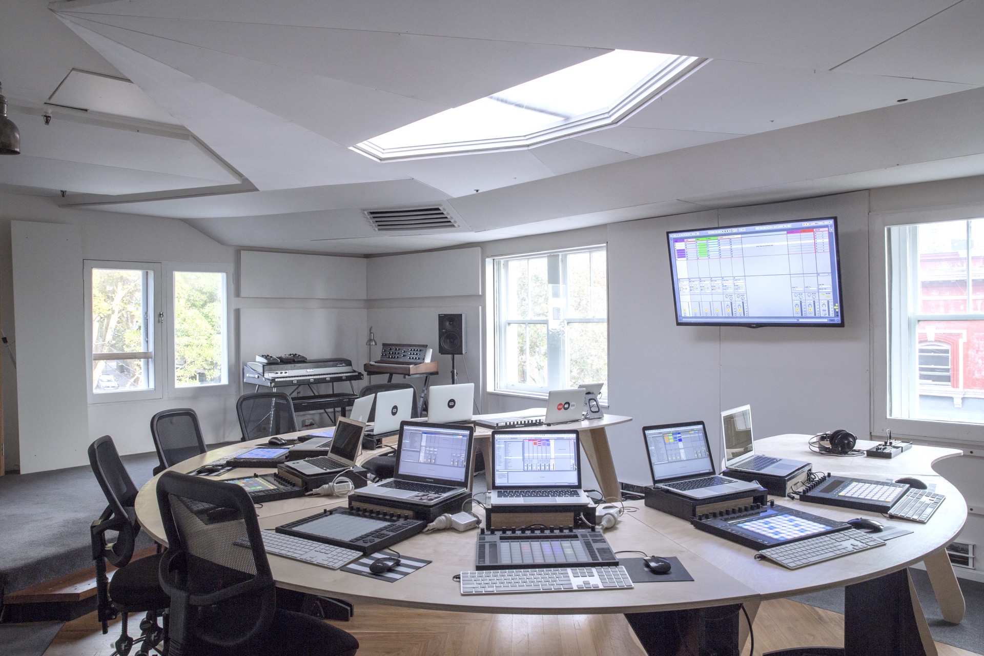 Studio classroom with workstations used for music production training.