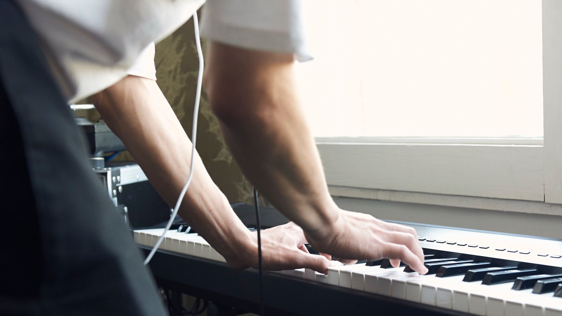 producer playing keys on a track