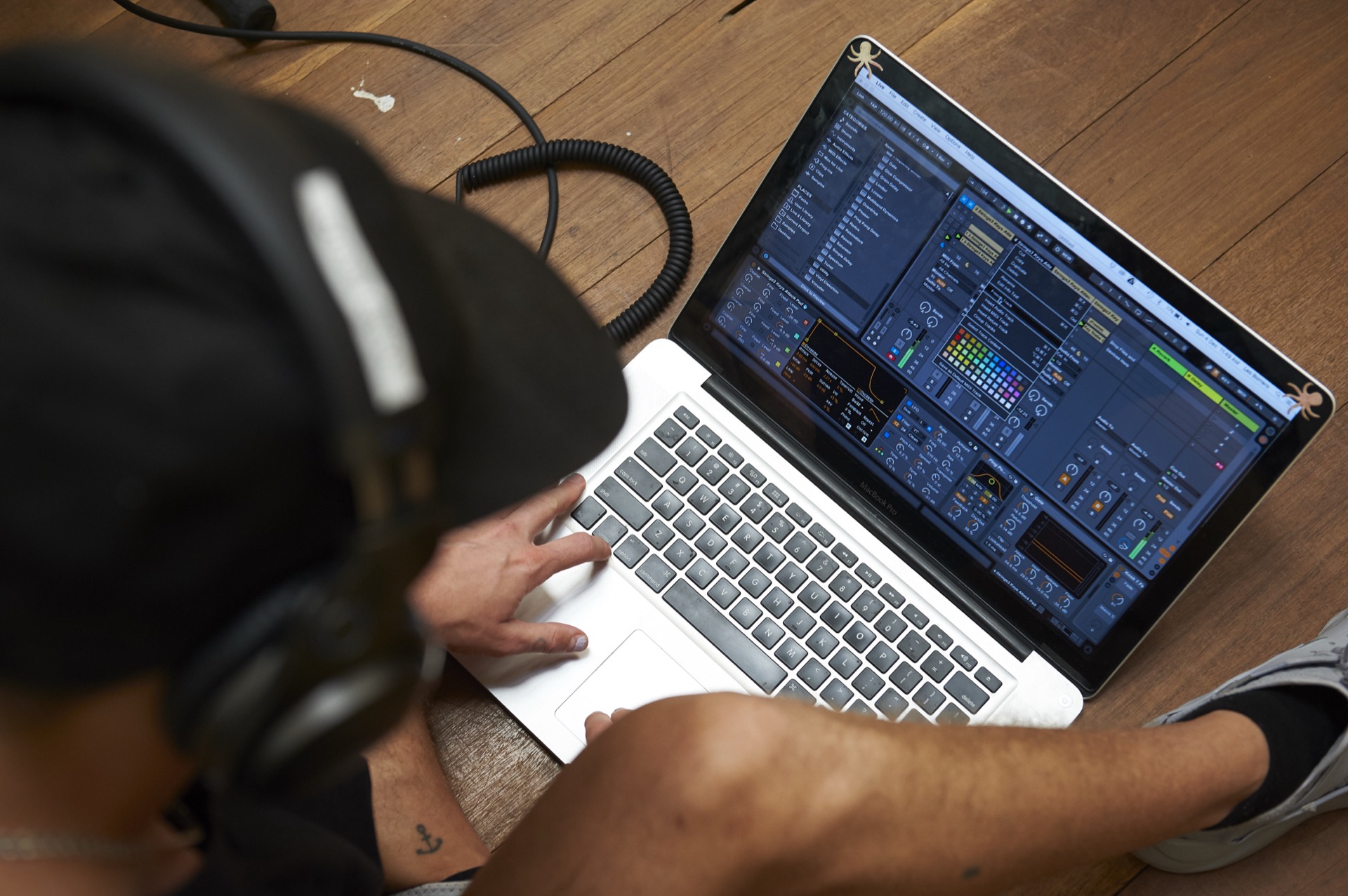 producer with laptop making music on the studio floor
