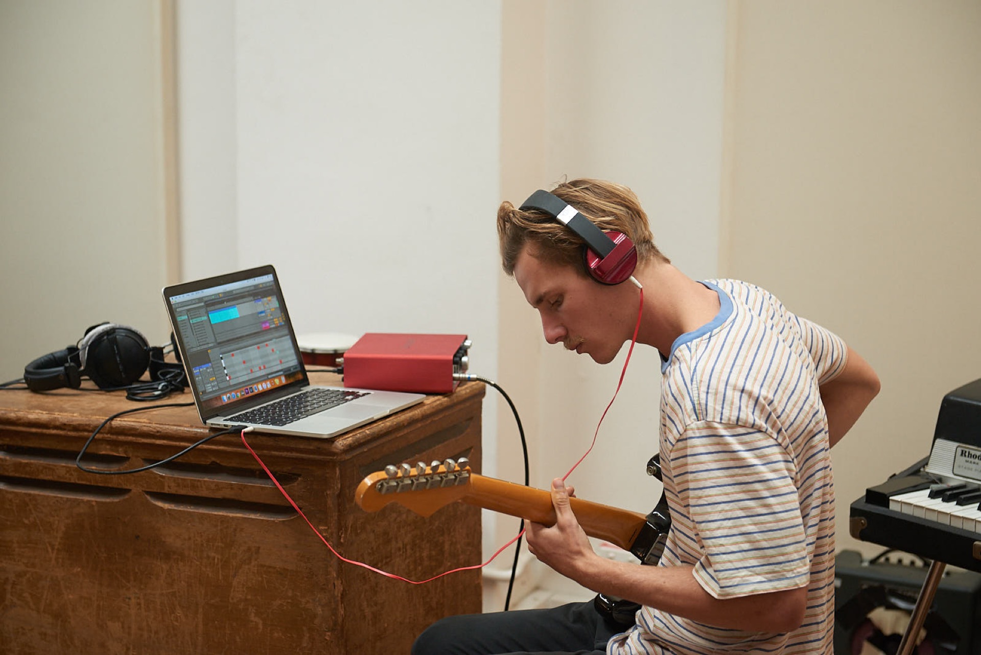 students recording guitar into Ableton Live in the studio.