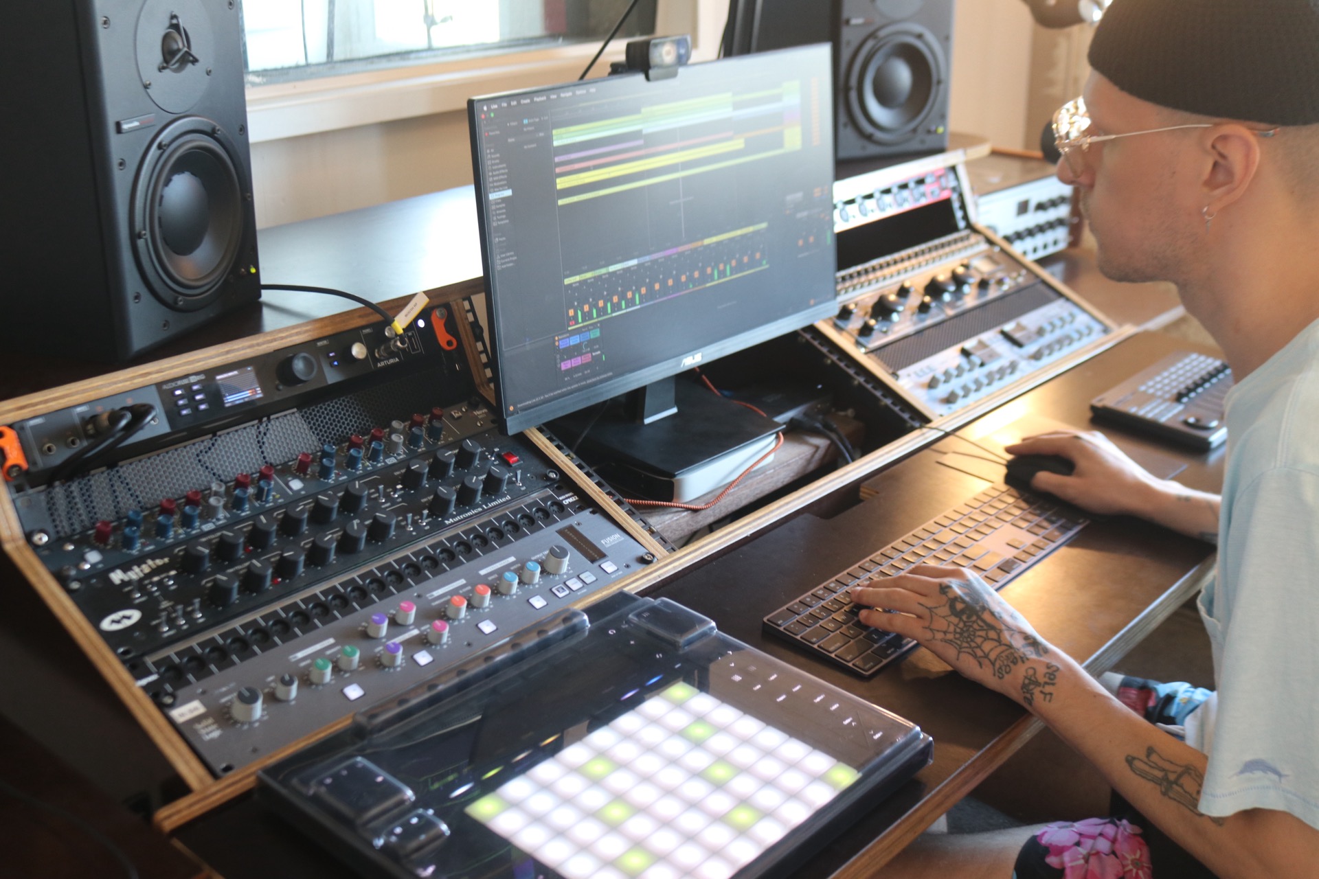 student working on an audio mix in a production studio with outboard audio equipment