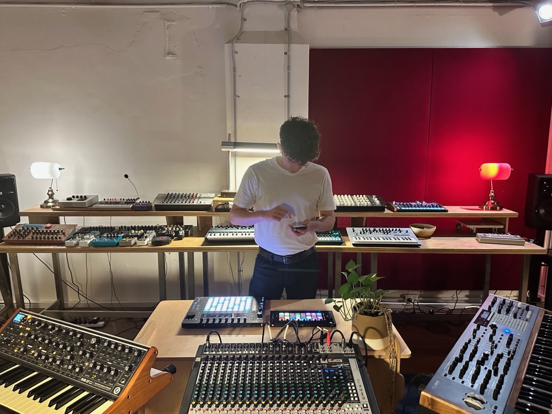 musician taking photos of Ableton Move and other music equipment in a music studio