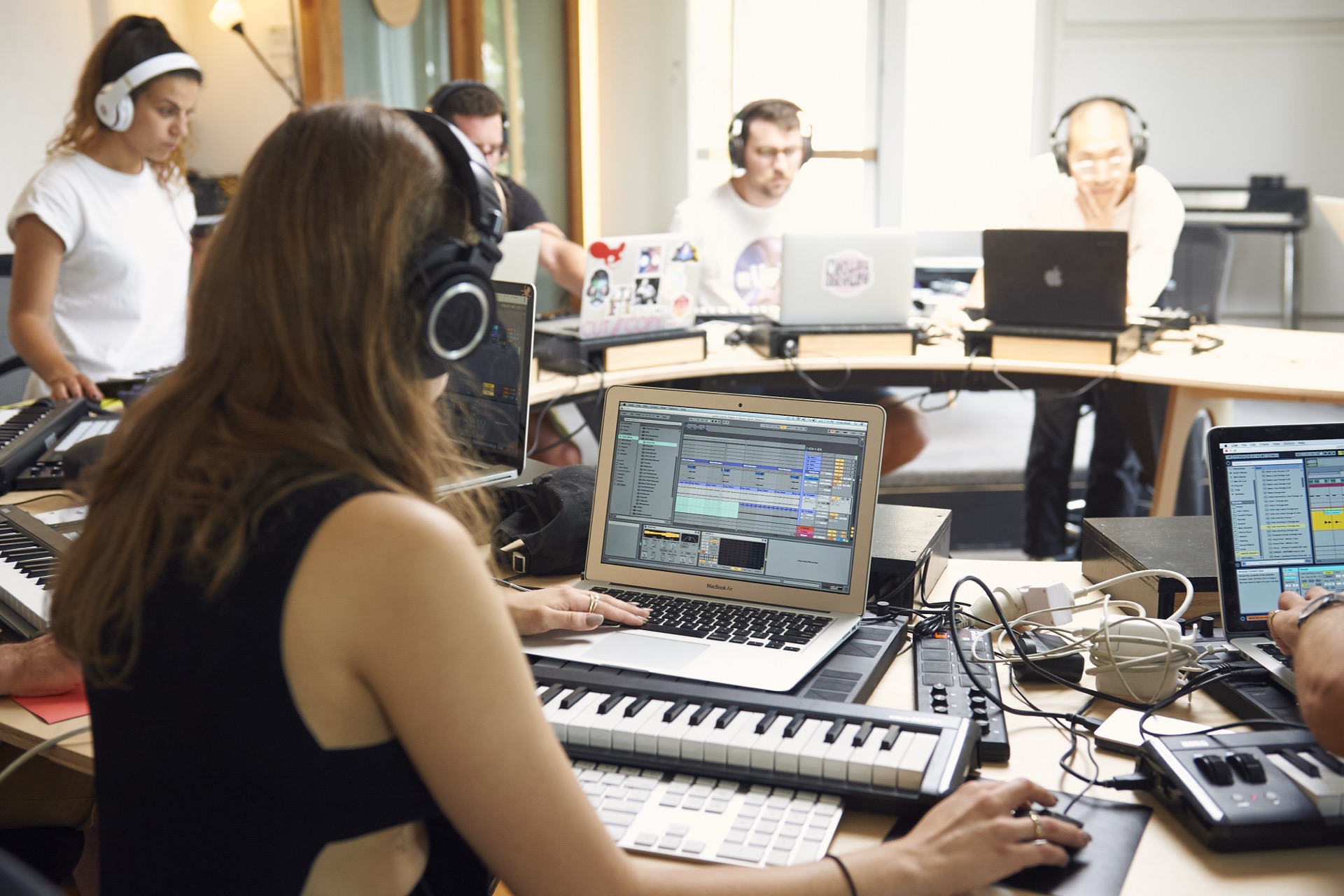 students making music in class with Ableton Live and MIDI controllers.